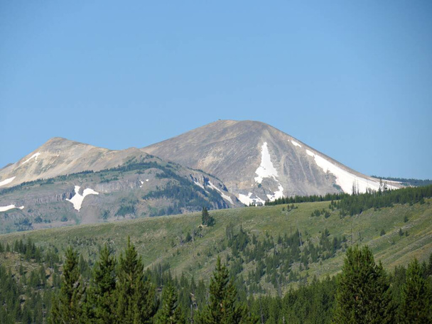 Tiro ascendente de montanhas distantes parcialmente cobertas de neve em
  - Foto, Imagem