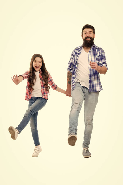 Following fathers example. On same wave concept. Bearded father and small child walking or running together. Move on. Lets move. Kid and dad cheerful friends in motion. Move in same direction - Photo, Image