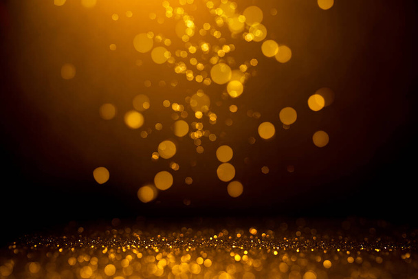 Golden abstract bokeh on black background. - Foto, immagini