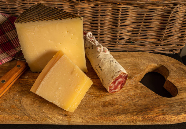 Cheese board and Iberian sausage on slate stone - Photo, Image