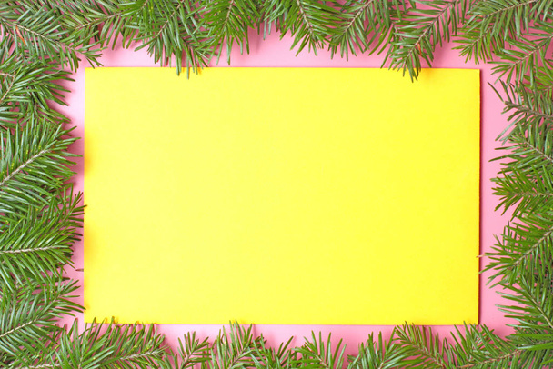 The concept of a New Year or Christmas greetings on a pink background, color envelopes, Christmas tree branches. - Fotografie, Obrázek