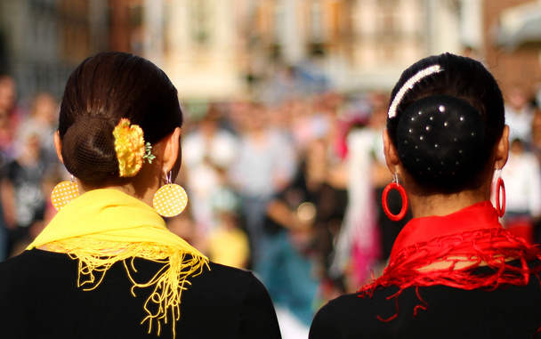 Heads of two women with very hairstyle and a yellow and red scar - Photo, Image