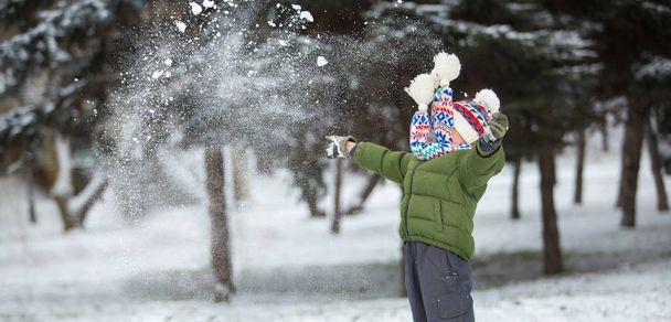 little child play with snow in winter scenery - Φωτογραφία, εικόνα