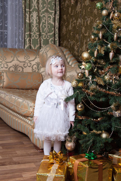 girl near a decorated Christmas tree - Φωτογραφία, εικόνα