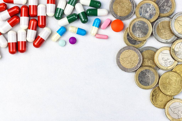 Financing of health care. Medicine, finance, health care and drug trafficking - medical pills or drugs and euro coin on white background. - Foto, immagini