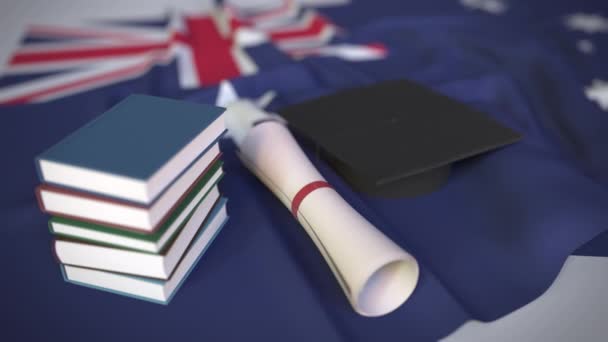 Καπέλο αποφοίτησης, βιβλία και δίπλωμα με την Αυστραλιανή σημαία. Τριτοβάθμια εκπαίδευση στην Αυστραλία σχετικές εννοιολογικές 3d animation - Πλάνα, βίντεο