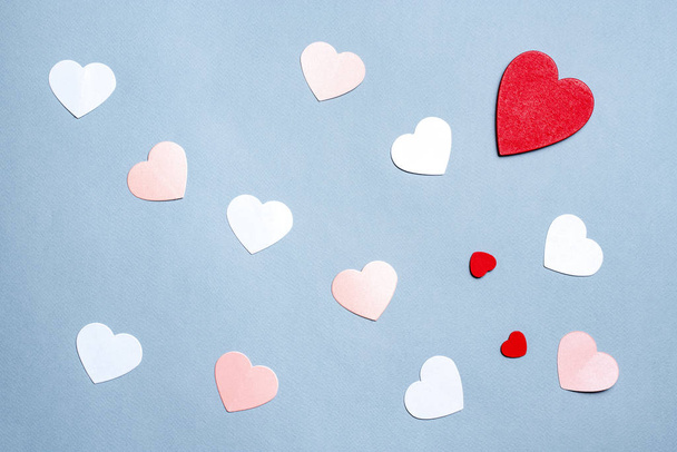Valentine's Day paper background. White and red hearts on pastel blue background. Valentines day concept. Flat lay, top view, copy space - Foto, Imagem