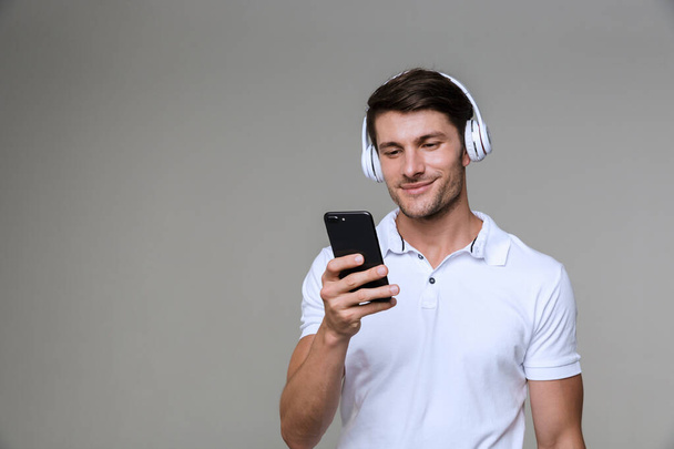 Emotional man listening music with headphones - Foto, afbeelding