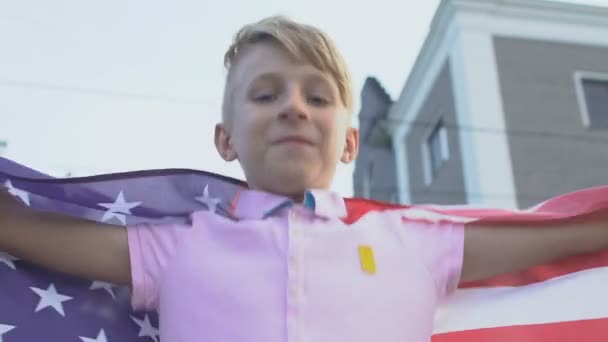 Happy boy holding american flag celebrating independence day, national pride - Felvétel, videó