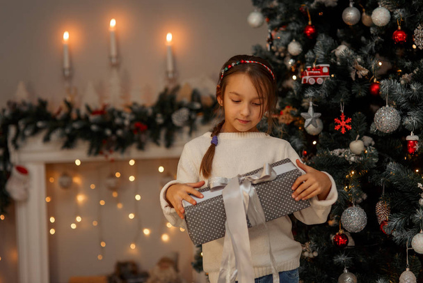 Happy little girl at home in Christmas eve - 写真・画像