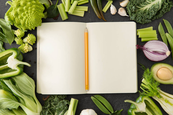 green vegetables and diary with empty pages - Foto, imagen