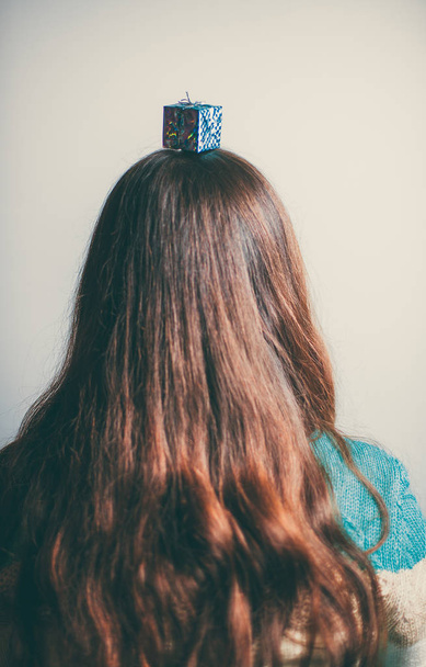 Beautiful Christmas toys on the head of a girl with long hair - Valokuva, kuva