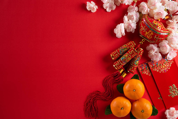 Chinese nieuwjaar festival decoraties pow of rood pakket, oranje en goud ingots op een rode achtergrond. Chinese karakters FU in het artikel verwijzen naar geluk, rijkdom, geldstroom. - Foto, afbeelding