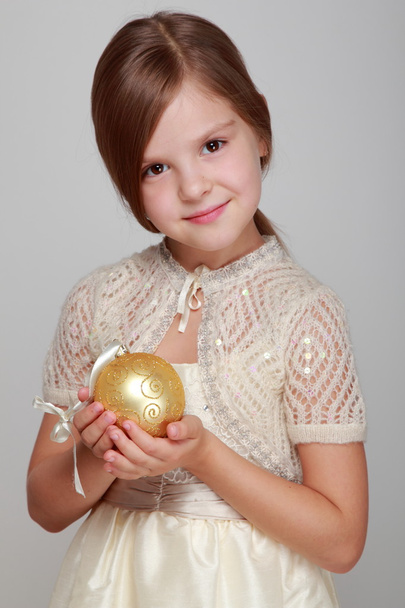 Girl holding a Christmas yellow balloon for - Valokuva, kuva
