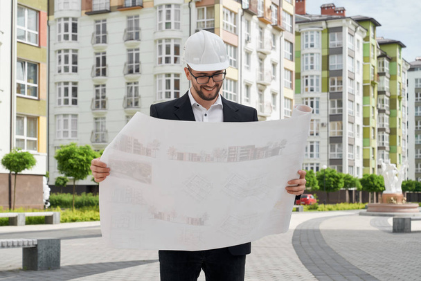 Architect in hardhat looking at construction projects. - Photo, image