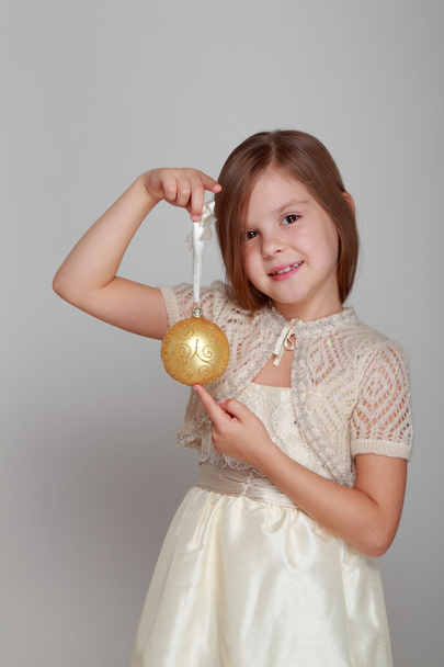 Girl holding a Christmas ball - Valokuva, kuva