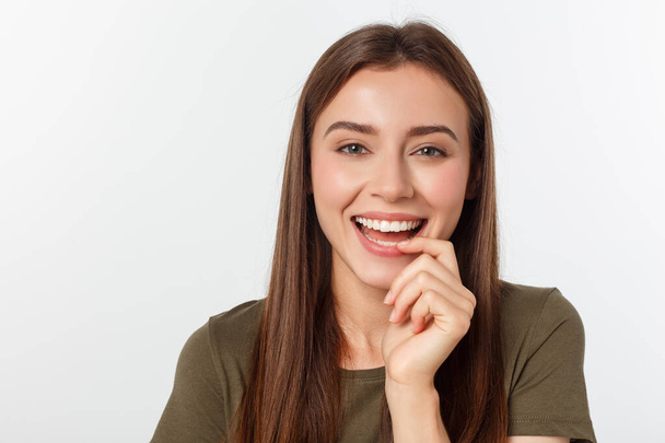 amazement - woman excited looking to the side. Surprised happy young woman looking sideways in excitement. Mixed race Asian and white Caucasian female model on grey background. - 写真・画像