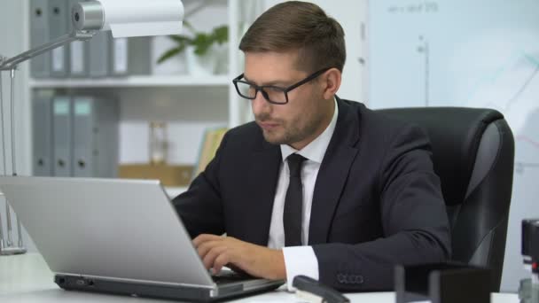 Man in business suit typing on laptop pc, feeling eye tension taking off glasses - Video