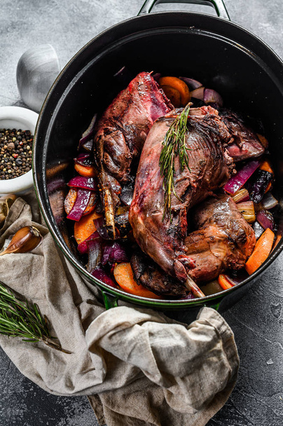 Roasted hare Haunches in stewpot with Stewed Vegetables. Cooking stew. Top view - Photo, Image