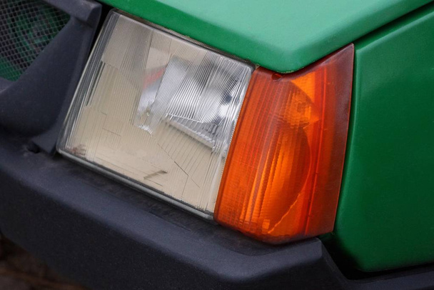 large glass color headlight on a green car - Photo, Image