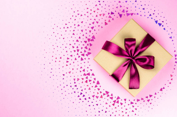 Nowy rok w tle. Pudełko świąteczne ze wstążką na różowo. Baner makieta do wyświetlania produktu lub treści projektu. Prezent świąteczny - Zdjęcie, obraz