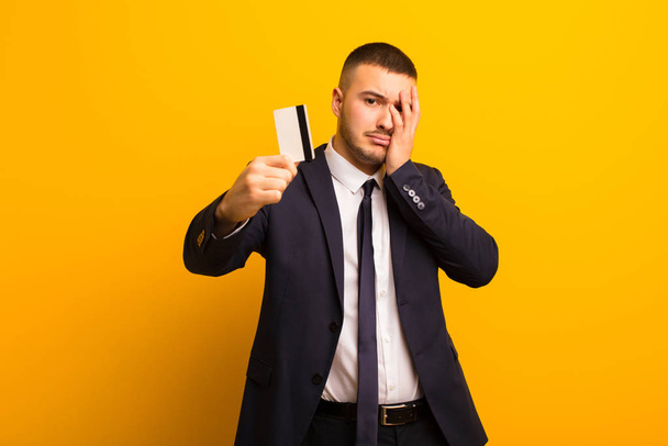 young handsome businessman  against flat background money concept - Foto, immagini