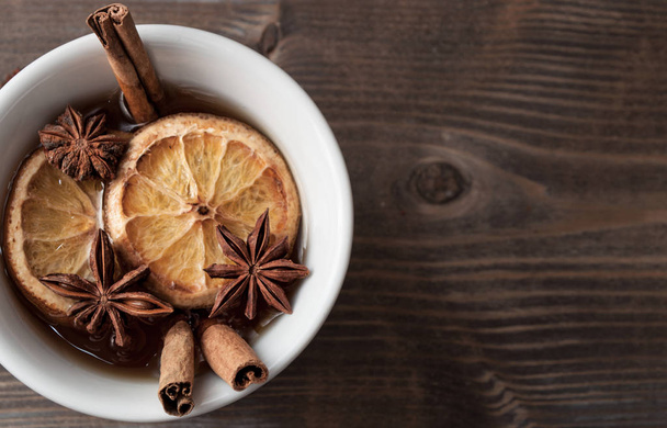 cup of black tea with anise, cinnamon and dried oranges - 写真・画像