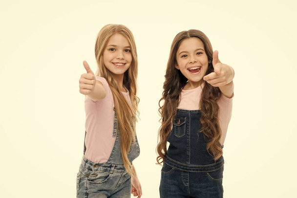 Sisterly relationship. Sisterhood happiness. Girls confident sisters. Sisterhood support or competition. Siblings relations. Well done. Sisterhood goals. Sisters kids isolated white background - Foto, Imagen