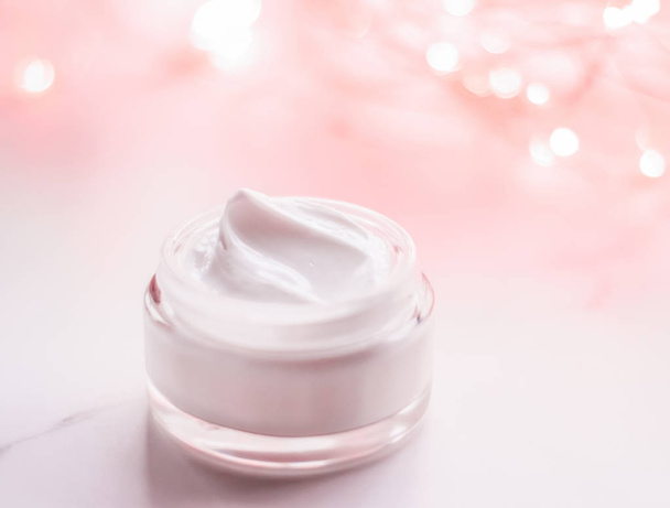 Facial cream moisturizer jar on holiday glitter background, mois - Фото, зображення