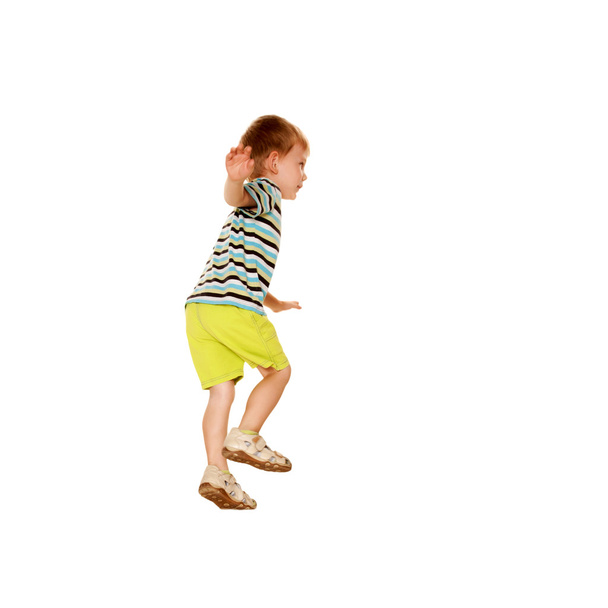Happy little boy in a striped T-shirt dancing. - Fotoğraf, Görsel