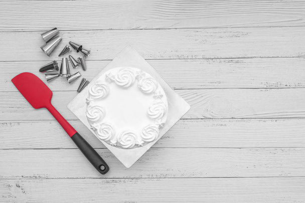 White fresh cream cake frosting with baking accessories utensils on table, flat lay one white background - Fotografie, Obrázek