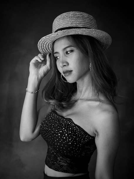 Portrait of Asian woman wearing dress and hat, black and white f - Photo, Image