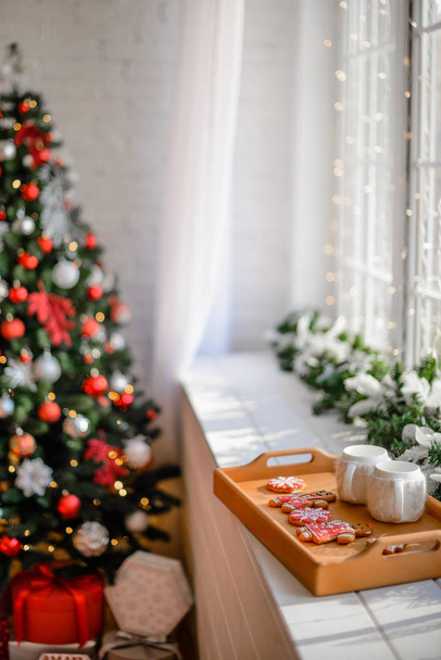 Beautiful holdiay decorated room with Christmas tree with presents under it - Photo, Image