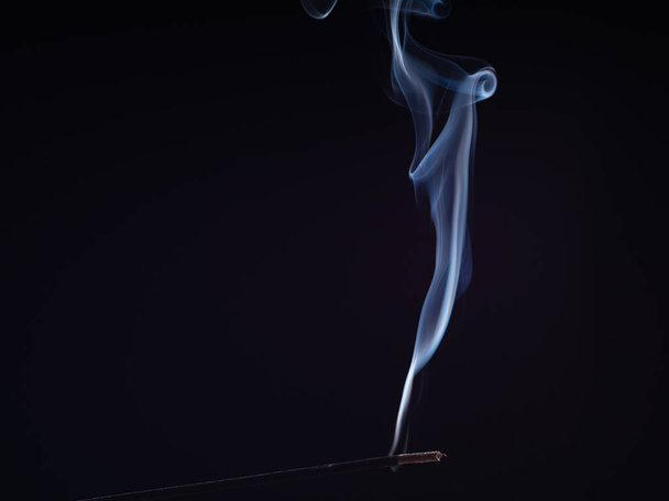 Steam of white smoke from burning incense, isolated on black background, close up view. Structure of smoke, brush effect. Abstract background of smouldering sweet smell. Smell for meditation. - Photo, image