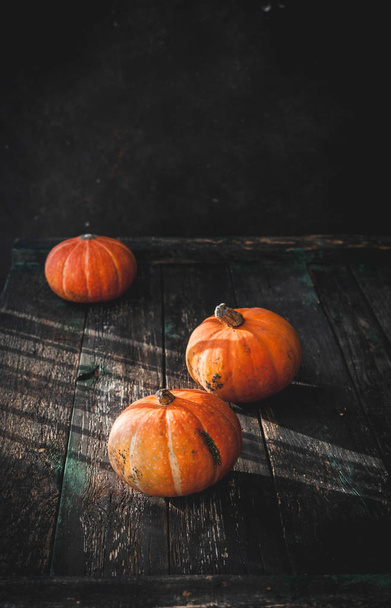 pumpkins on old wooden table in natural light , thanksgiving day concept  - Foto, afbeelding