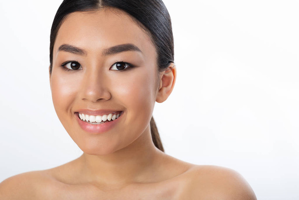 Beauty portrait. Asian woman with white smile and clean skin - Fotó, kép