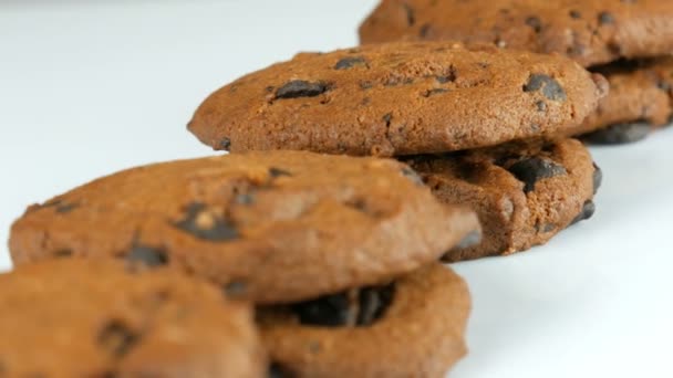 Chocolate cookies on stylish white ack background and a mirror surface - Footage, Video