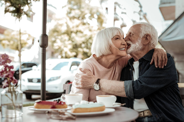 Joyful senior man wanting to kiss his wife - Zdjęcie, obraz