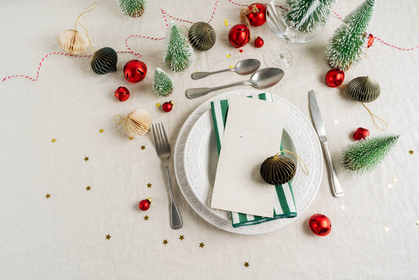 Beautiful table setting on grey background with white plates, glass, cutlery silverware, champagne and Christmas decorations. Holiday layout with copy space. - Foto, Bild