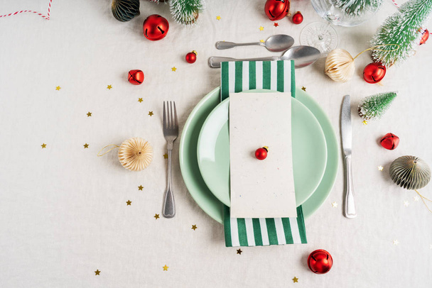 Beautiful table setting on grey background with white plates, glass, cutlery silverware, champagne and Christmas decorations. Holiday layout with copy space. - Zdjęcie, obraz