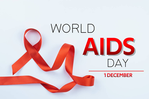 Aids awareness, red ribbon on white background with copy space f - Foto, Imagen