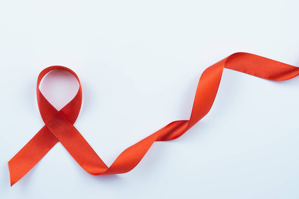 Aids awareness, red ribbon on white background with copy space f - Photo, Image