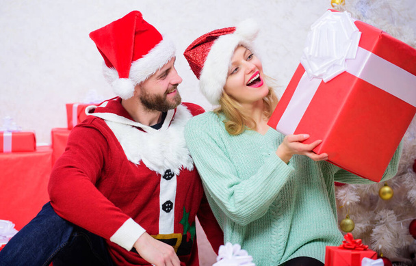 Opening christmas present. What a surprise. Loving couple unpacking gift christmas tree background. Husband prepared christmas surprise. Couple in love happy enjoy christmas holiday celebration - Foto, afbeelding