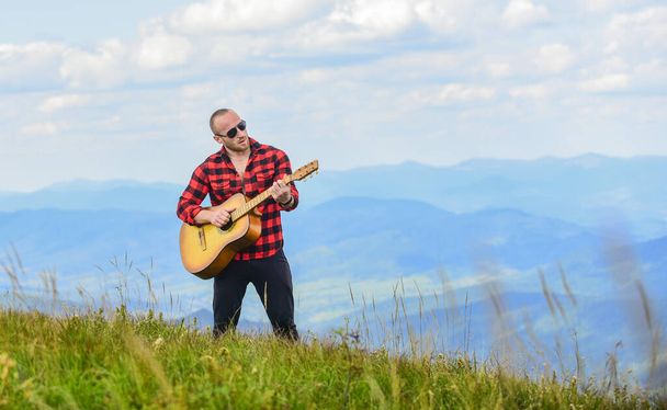 Your number one rock station. acoustic guitar player. country music song. sexy man with guitar. hipster fashion. western camping and hiking. happy and free. cowboy man play guitar outdoor - Фото, изображение