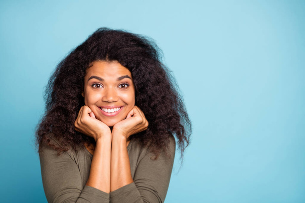 Close up photo of funky cheerful positive mulatto girl look feel excited dreamy on her weekends wear stylish pullover isolated over blue color background - Foto, imagen