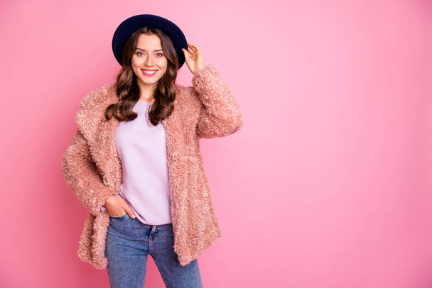 Photo of beautiful millennial lady amazing street look holding hand in pocket wear stylish winter fluffy jacket retro hat jeans isolated pink background - 写真・画像