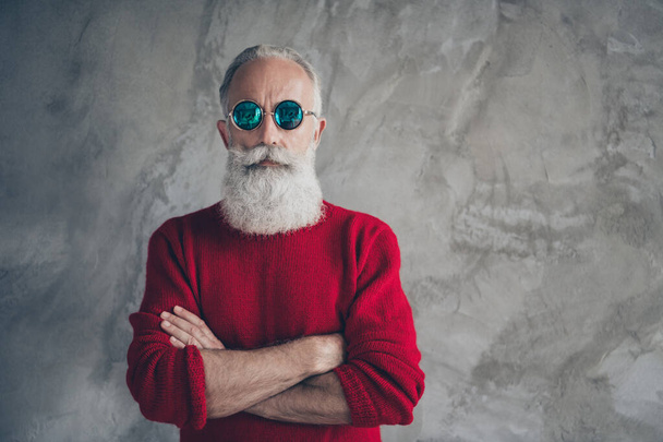 Portrait of serious harsh masculine old man cross hands look stunning prepare s-mas party time celebration wear stylish pullover isolated over grey concrete wall color background - 写真・画像