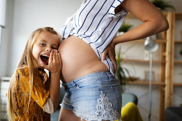 Happy family. Beautiful pregnant mother with cute child - 写真・画像