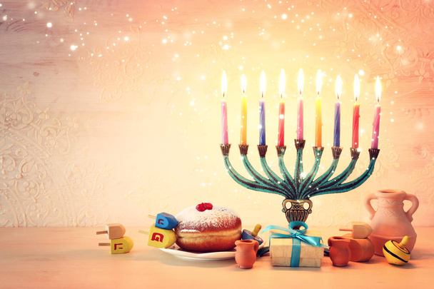 religion image of jewish holiday Hanukkah background with menorah (traditional candelabra), spinning top and doughnut - Foto, imagen