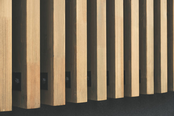 Building facade with modern wooden vertical planks installed on steel brackets - Foto, imagen